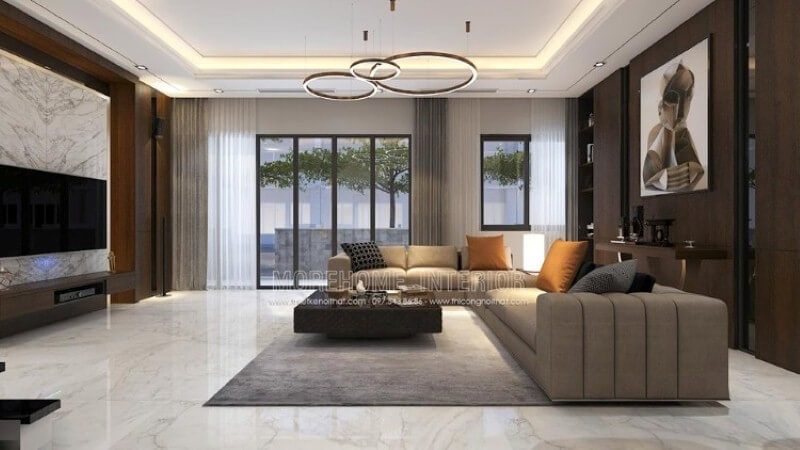 Bố trí nội thất phòng khách thể hiện vẻ đẹp nổi bật với mọi ánh nhìn. Ngồi trên chiếc sofa êm ái chiêm ngưỡng bức tranh trừu tượng như một ẩn số khiến ta tò mò những giây phút tĩnh lặng hay thay đổi sự quan tâm sang chiếc tivi giúp tầm mắt được nhìn một cách tập trung với cách trang trí khối đá đối vân trắng.